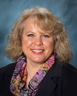 Ms. Qualey with multicolored scarf and blue jacket 
